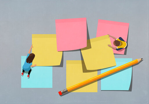 Schoolchildren arranging large multicolor adhesive notes
