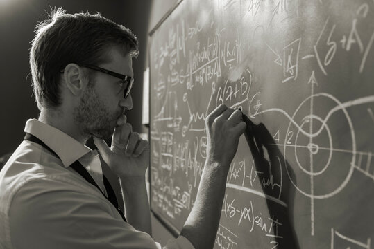 Young Smart Mathematician Drawing On The Chalkboard