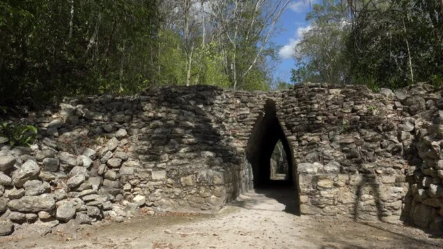 Tourist is walkikng through the arched narrow passage at Becan Mayan Ruins. Campeche, Mexico.