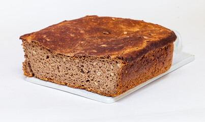 Rye homemade bread on a ceramic cutting Board on white background