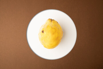 quince fruit on brown background