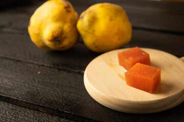 quince fruit on black wooden background