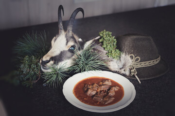 celebration after the chamois hunt with a plate of venison goulash 