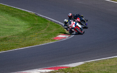 A shot of two racing bikes cornering on a track.