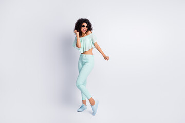 Fototapeta na wymiar Full length body size photo of cheerful funky black skinned girl wearing sunglass dancing at party isolated on grey color background
