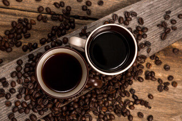 Coffee and coffee beans on old rustic wood table