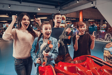 Family rejoices for playing well in a video game. © freeograph