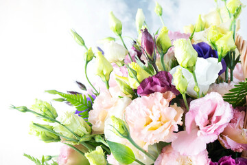 Amazing bouquet of colored roses close up. Fresh roses with water drops on the petals and unblown yellow rosebuds in a bouquet. Wedding and Valentine's Day concept