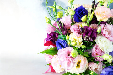 Beautiful flower arrangement of fresh multicolored roses. There are drops of water on the petals of flowers. Holiday concept: wedding, women's day, mother's day, valentine's day. Close-up