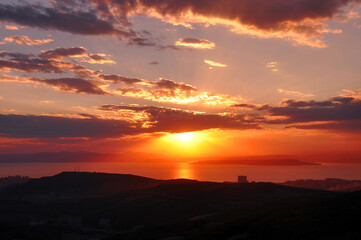 Naklejka na ściany i meble Sunset over the sea and beautiful cloudscape. Japanese sea, Vladivostok city, Primorsky Krai, Russia.
