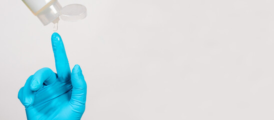 Applying the lubricant of Vaseline on the blue glove before the rectal examination of the rectum...