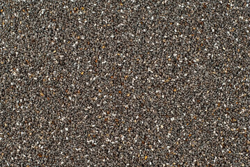 Chia seeds close up. Grain texture on a black background.