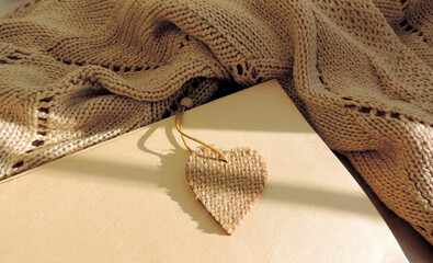 evening cozy composition with warm knitted plaid, sketchpad with place for text, for love message,...