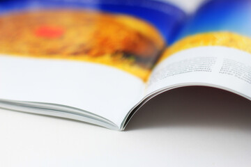 Magazines on the table, desk in the office.