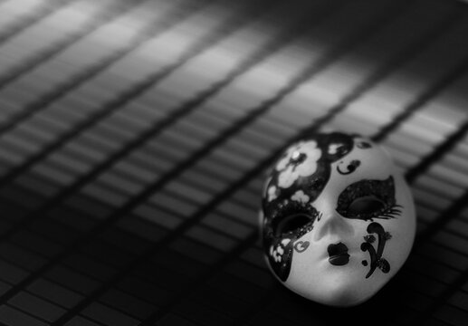 Small Venetian mask on a surface.