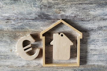 house modell with euro sign on wooden background
