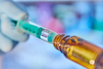 Close up of a syringe with vaccine. Close up of a flask with vaccine. Coronavirus vaccine in a syringe. Vaccine candidate. Pfizer vaccine. Biontech vaccine. Vial with vaccine. Moderna vaccine.