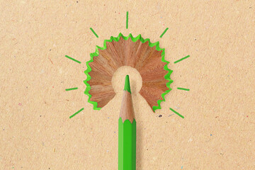 Green pencil like a light bulb on recyced paper background - Concept of ecology and creative...