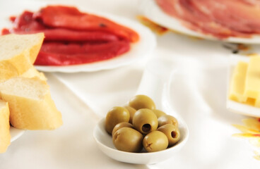 Olive and meat on the plates for eating.