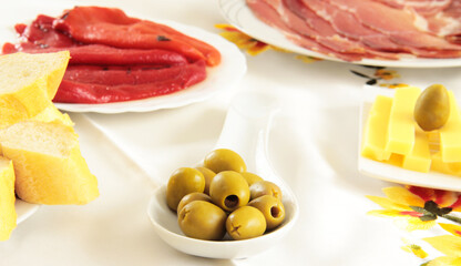 Olive and meat on the plates for eating.
