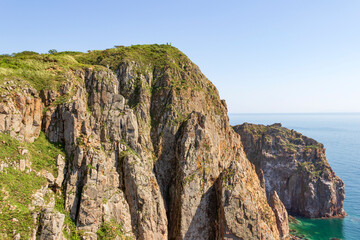 Picturesque landscape overlooking the rocks and the sea on a sunny summer day on the Shkota island in Vladivostok.