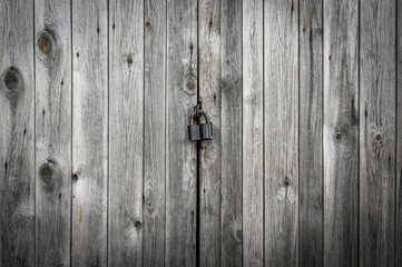 Locked brown old wooden fence
