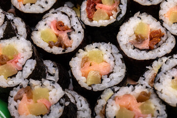 Top view of stack of Japanese sushi maki roll plate. Served in Japanese bar restaurant with chopstick