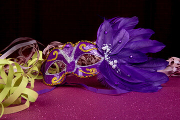 Carnival masks, Venetian masks on shiny surface with streamers, selective focus.