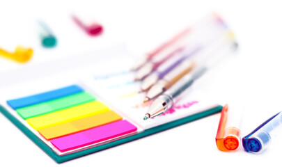 Naklejka premium Various colored pencils, paper, notes on white background.