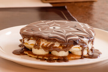 Pancake with chocolate, banana and cream