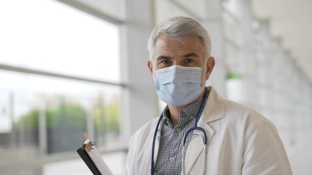 Portrait of doctor working in office with face mask