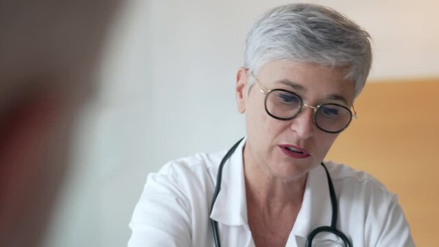 Mature woman doctor in medical consultation with patient 