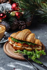 New Year's breakfast with croissants. New Year's croissant with red fish and avocado. New Year and Christmas concept