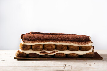 Traditional tiramisu cake isolated on white background