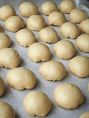 Fototapeta na wymiar mini bread roll dough on baking paper