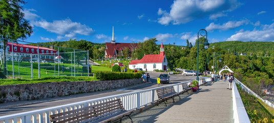 TADOUSSAC, CANADA - AUGUST 2008: Waterfront with tourists on a beautiful summer day