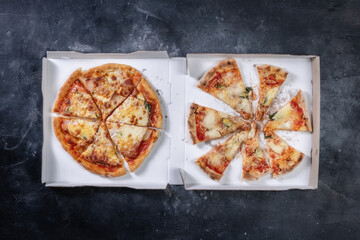 Pizza from box on dark table
