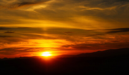 Fototapeta premium Scenic sunset, red sky, and silhouette hills. Lake District, England.