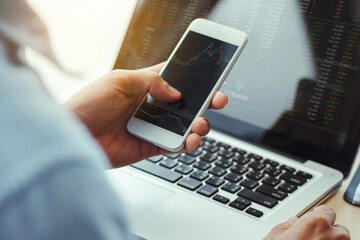 Businessman analyzing stock market investments with financial dashboard,on smartphone and computer screens.Corona vaccine discovery boosts stock markets.