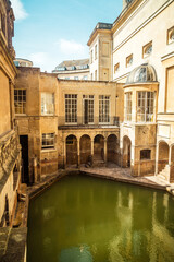 Fototapeta na wymiar BATH, ENGLAND - AUG 30, 2019 : Roman Baths, the UNESCO World Heritage site with people, which is a site of historical interest in the city of Bath.