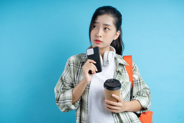 Fototapeta premium students holding books and cell phones are thinking