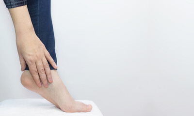 An orthopedic examines a woman's leg. Heel pain, tendon stretching, inflammation, heel spur. Foot...