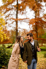 Young couple walking in the autumn park
