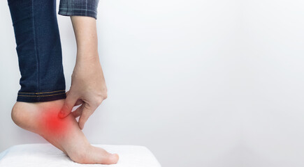 An orthopedic surgeon examines a woman's leg. Foot pain, tendon sprains, inflammation, flat feet,...