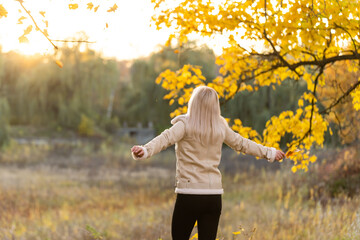 Beautiful elegant woman standing in a park in autumn , Fall concept