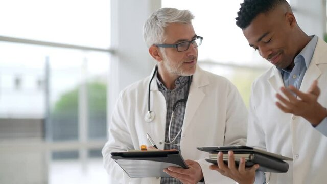 Group of doctors meeting in hospital for instructions and medical report 