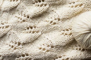 light warm openwork knitted blanket and balls of yarn. knitted background. home comfort