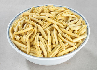 Bhavnagari Gathiya or gathia, ganthia, ganthiya, papdi, Champakali made by gram flour, Indian Pouch Packing Street Food, Namkeen or namkin, selective focus - Image