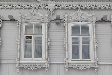 Ornamental carved windows, decorative frames on vintage wooden house on Pushkin Street, 34, Tomsk...