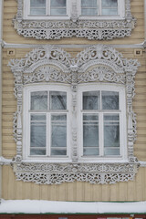 Ornamental carved windows, decorative frames on vintage wooden house on Pushkin Street, 38, Tomsk...